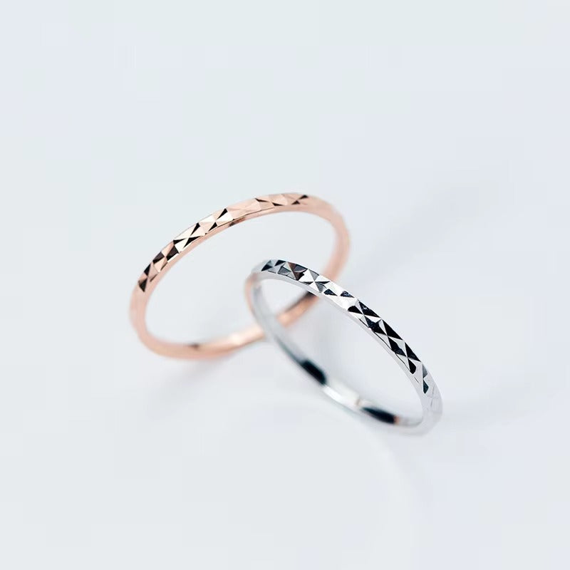 Two 925 sterling silver diamond-cut rings in silver and rose gold finishes
