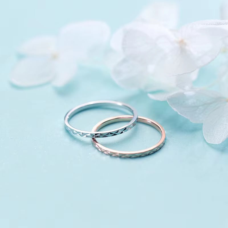 Two 925 sterling silver diamond-cut rings in silver and rose gold finishes