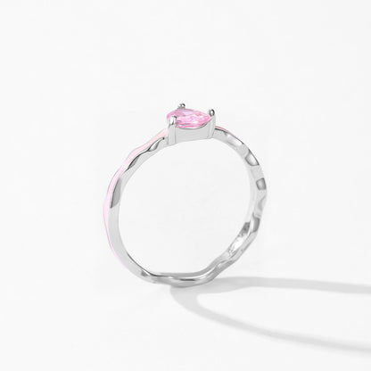 Silver ring with a pink gemstone on a white background