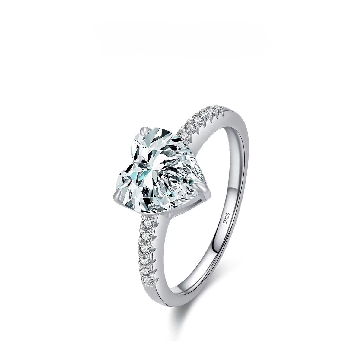 Silver ring with a large heart shaped gemstone on a white background