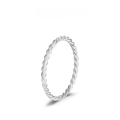 Silver ring with a braided design on a white background