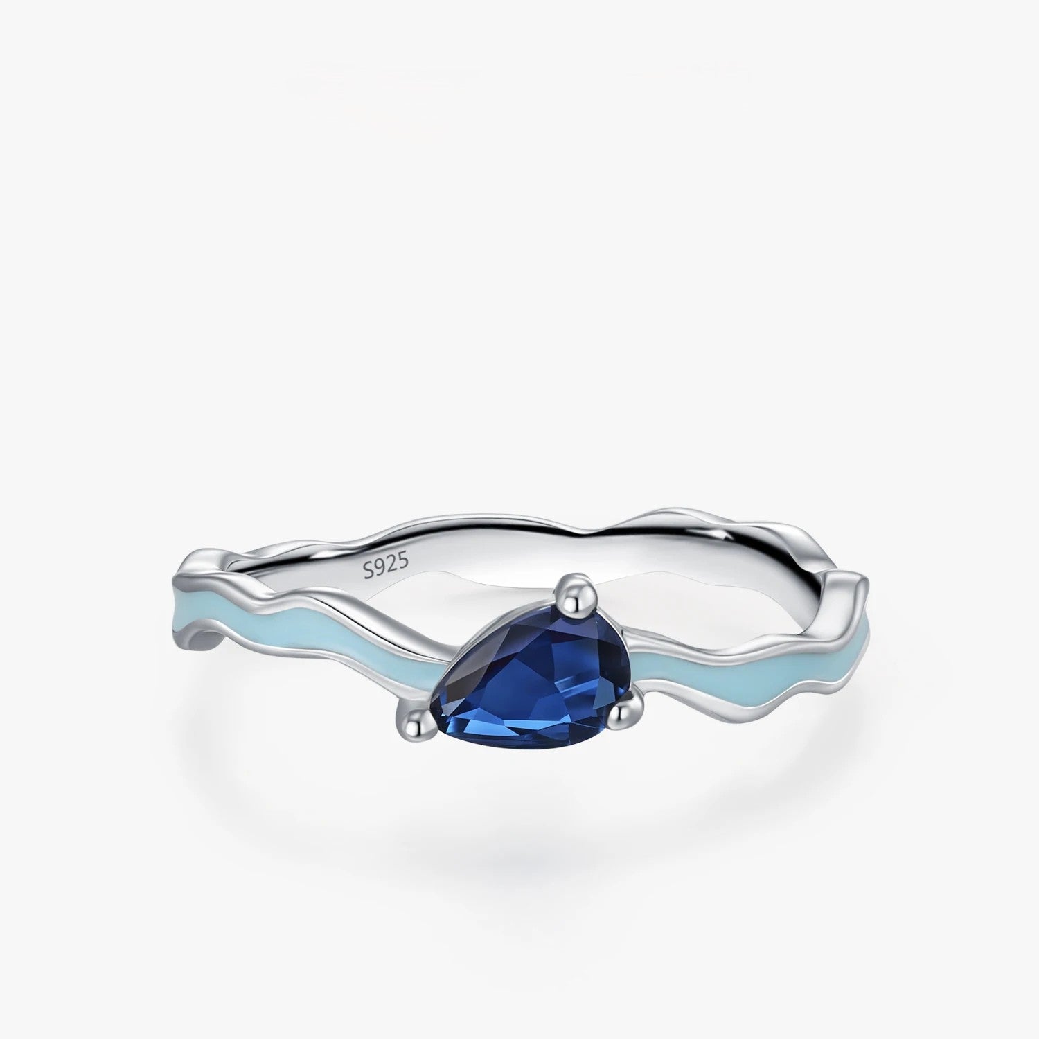 Silver ring with a blue gemstone on a white background