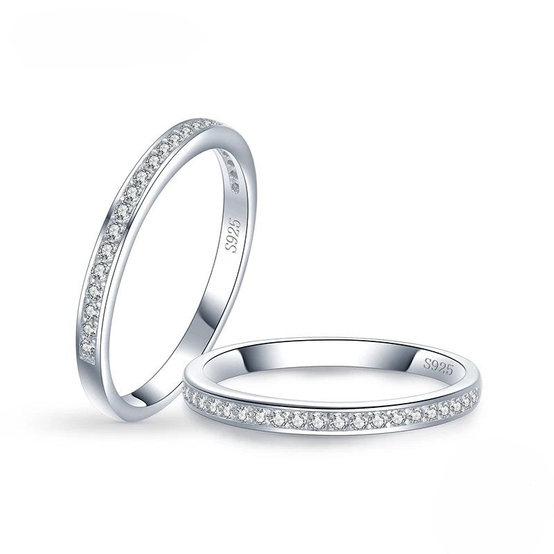 Two silver rings with zircon accents on a white background