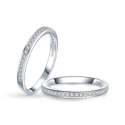 Two silver rings with zircon accents on a white background