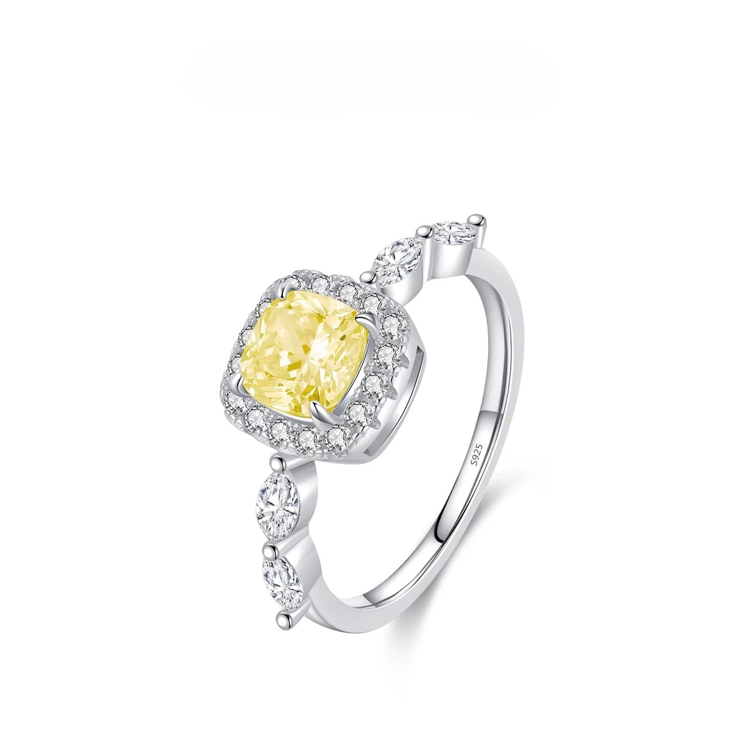 Silver ring with a yellow gemstone on a white background