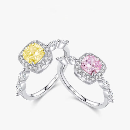 Two zircon rings with yellow and pink gemstones on a white background