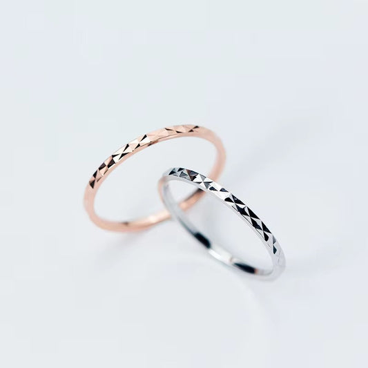 Two 925 sterling silver diamond-cut rings in silver and rose gold finishes
