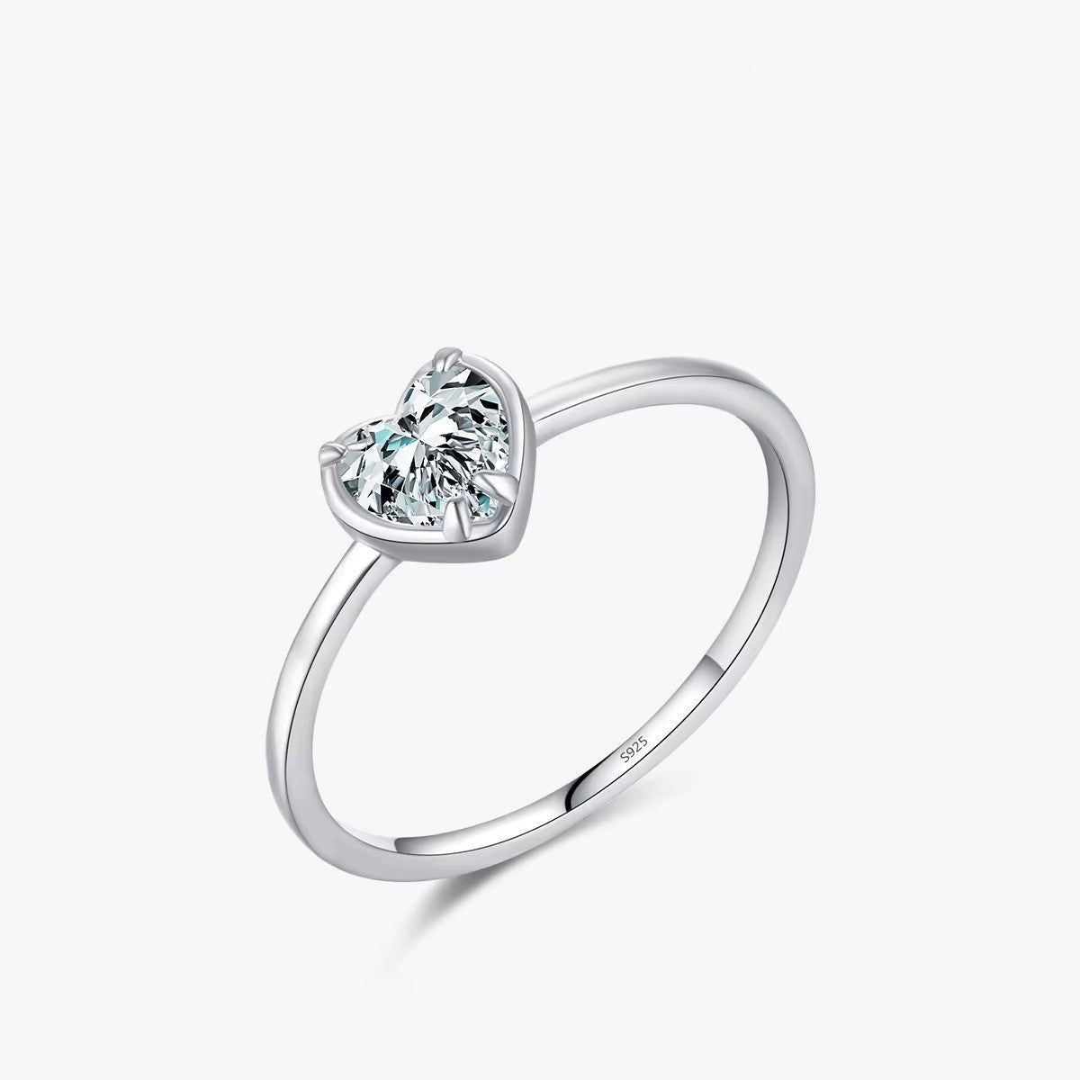 Silver ring with a heart-shaped zircon on a white background