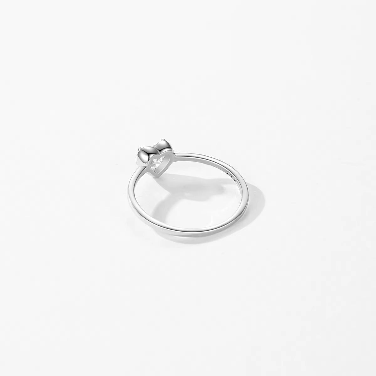 Silver ring with a small zircon on a white background