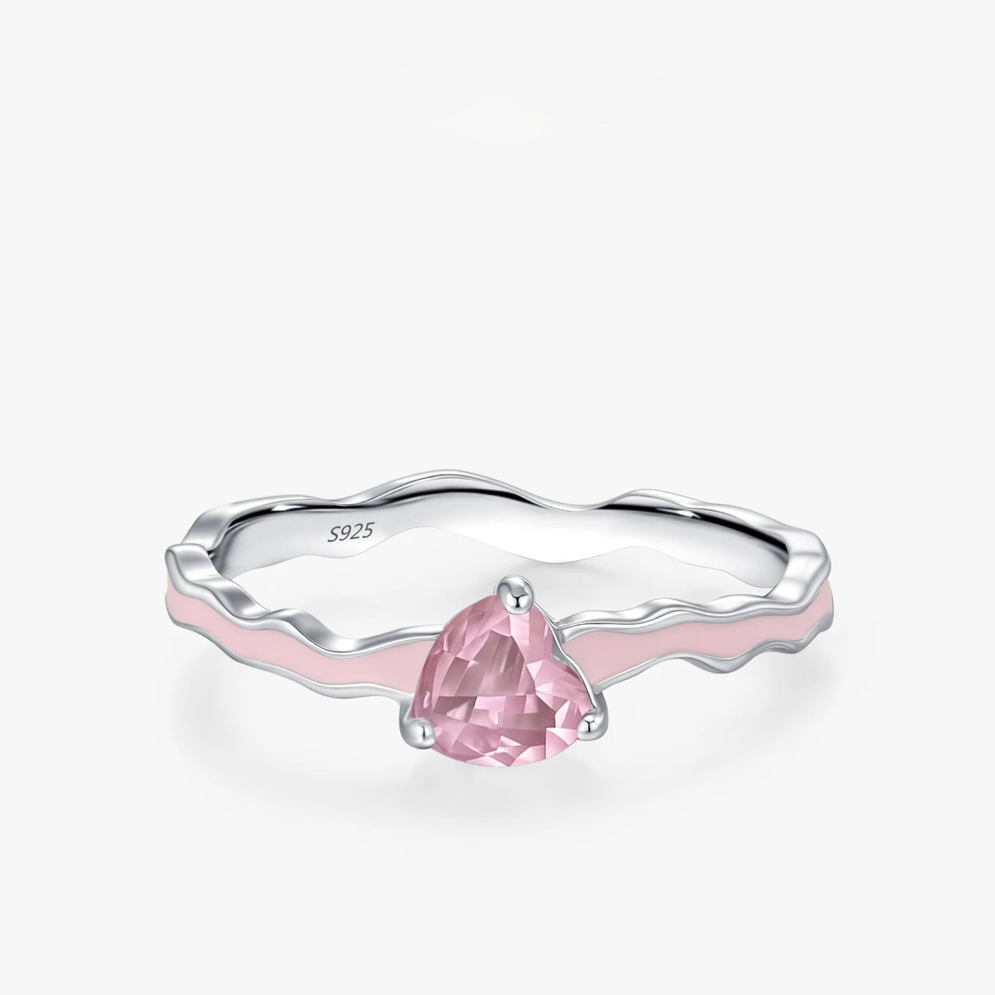 Silver ring with a pink gemstone on a white background