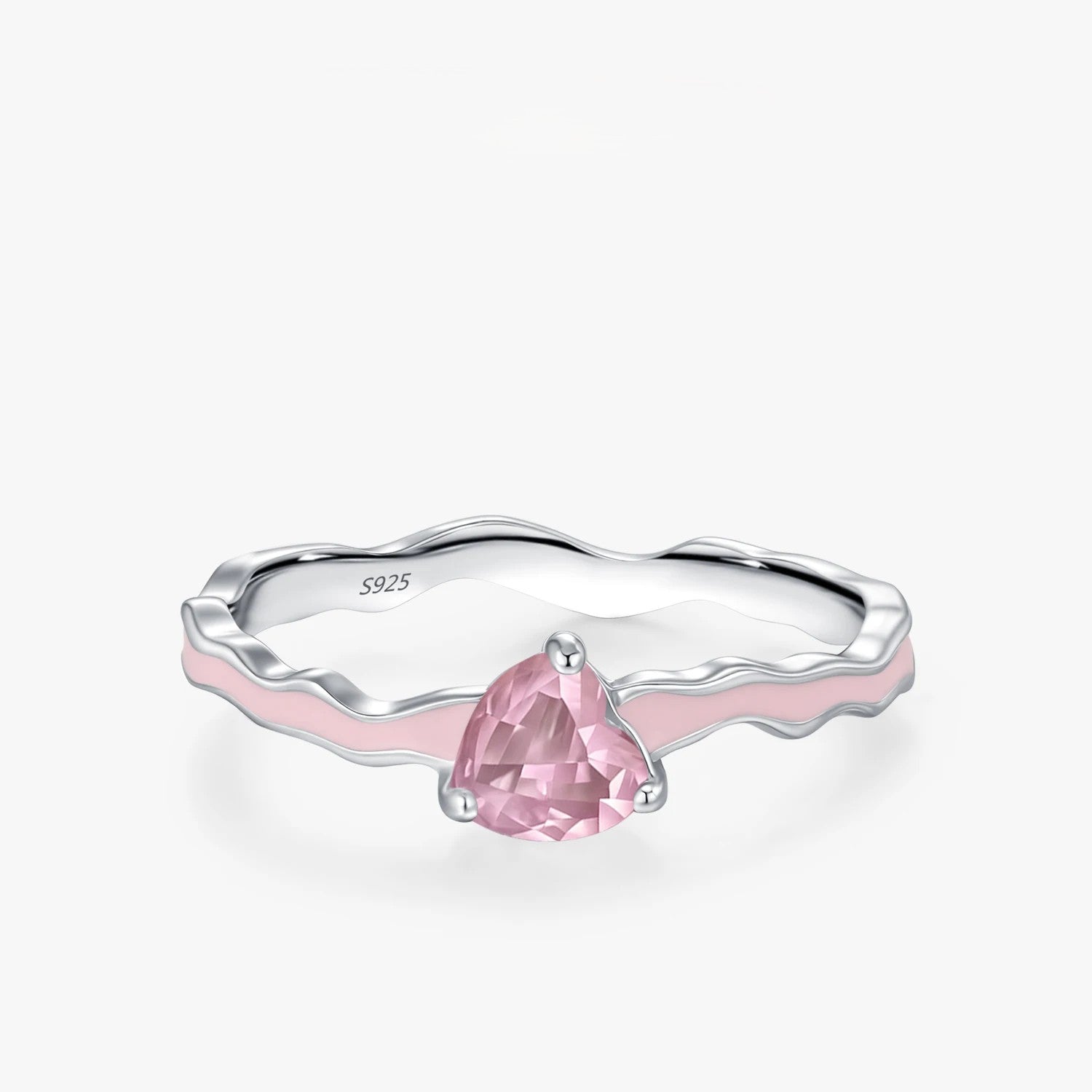 Silver ring with a pink gemstone on a white background