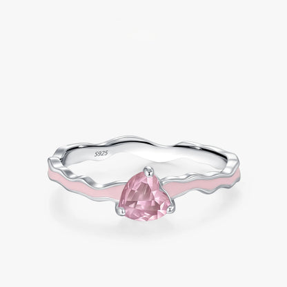 Silver ring with a pink gemstone on a white background
