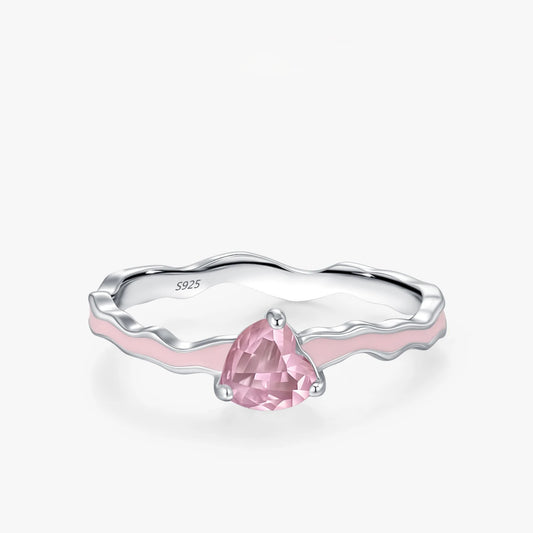 Silver ring with a pink gemstone on a white background