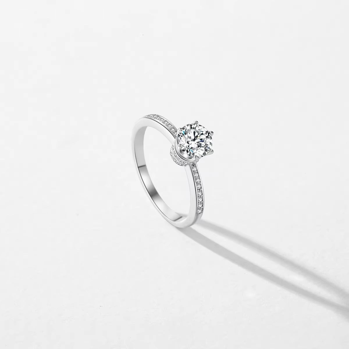 Silver ring with a zircon on a light gray background