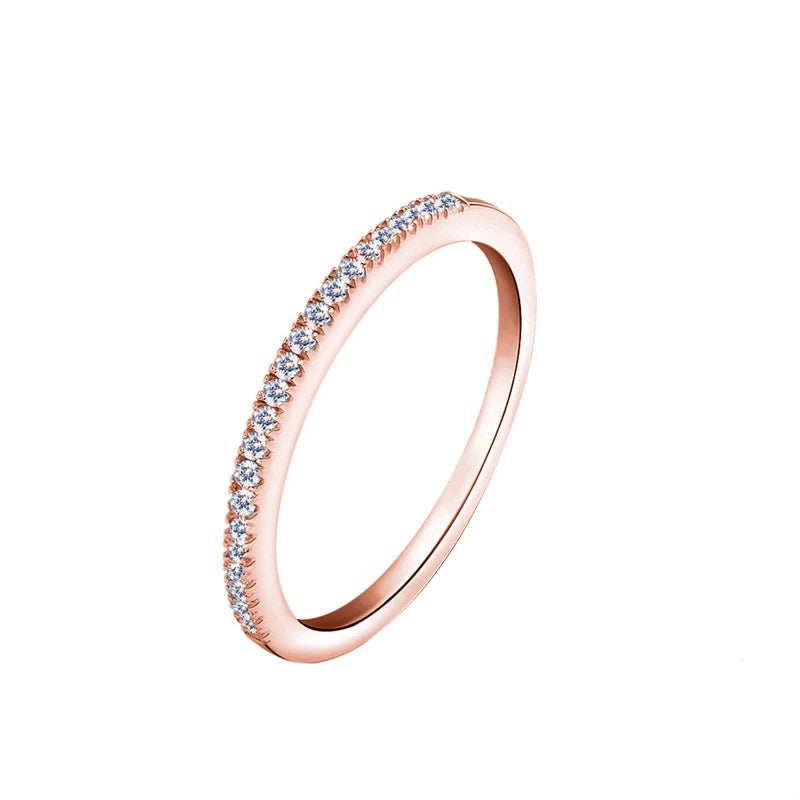 Rose gold ring with small zircons on a white background