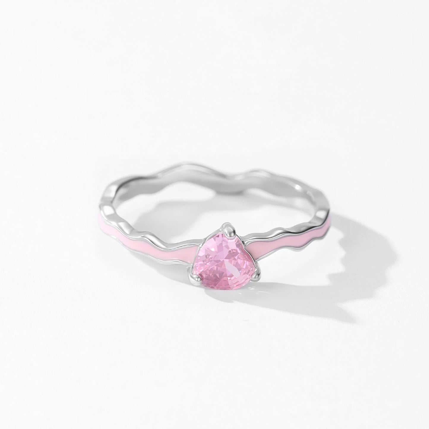 Silver ring with a pink teardrop-shaped gemstone on a white background