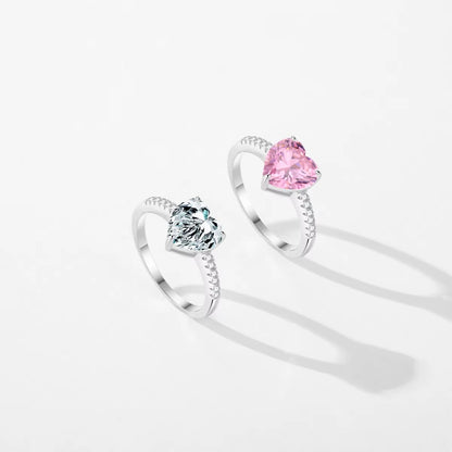 Two silver rings with gemstones on a white background