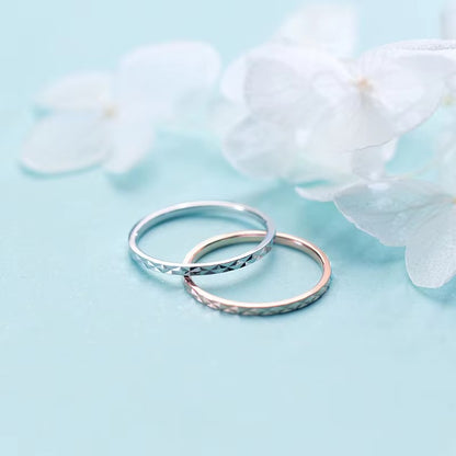 Two 925 sterling silver diamond-cut rings in silver and rose gold finishes