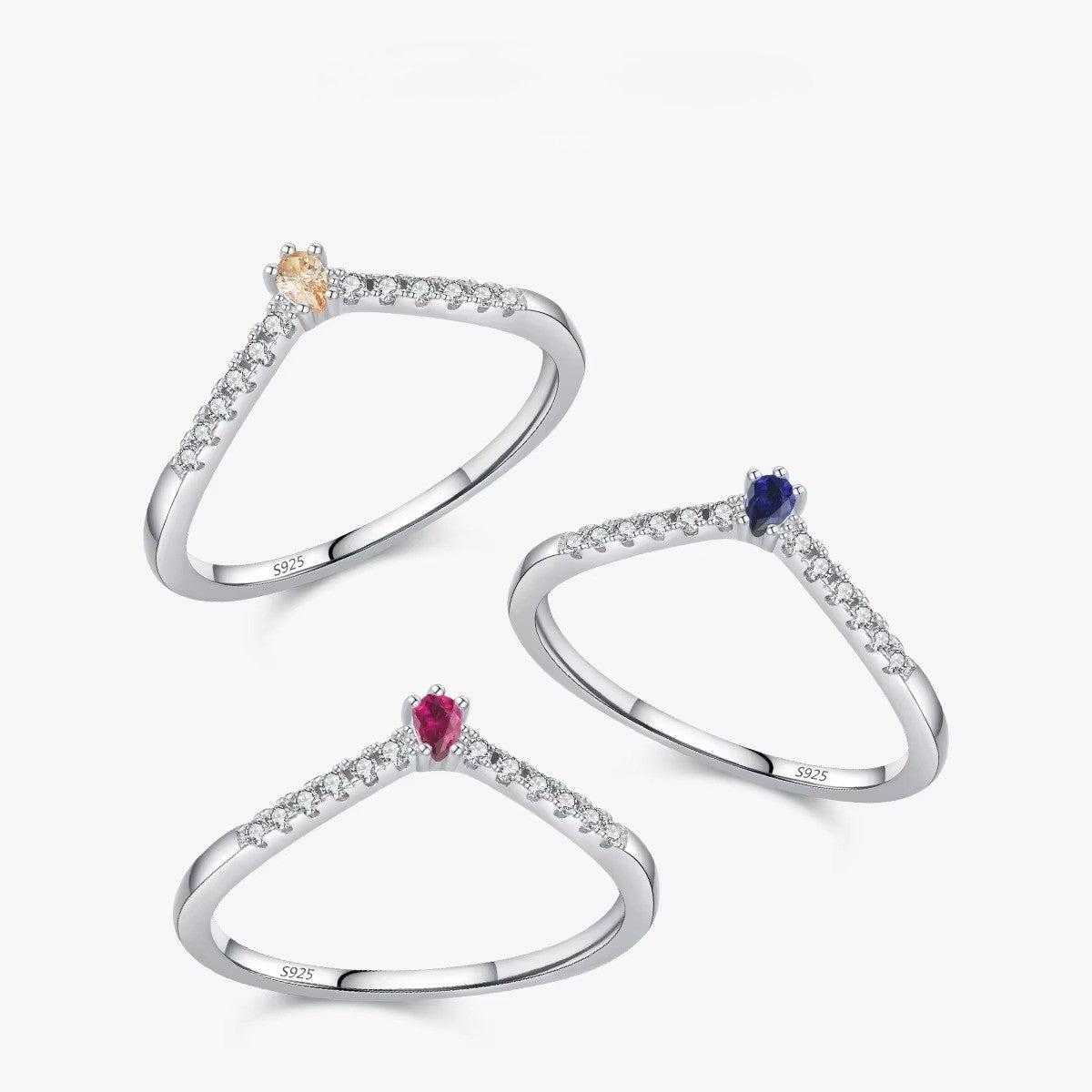 Three silver rings with gemstones on a white background