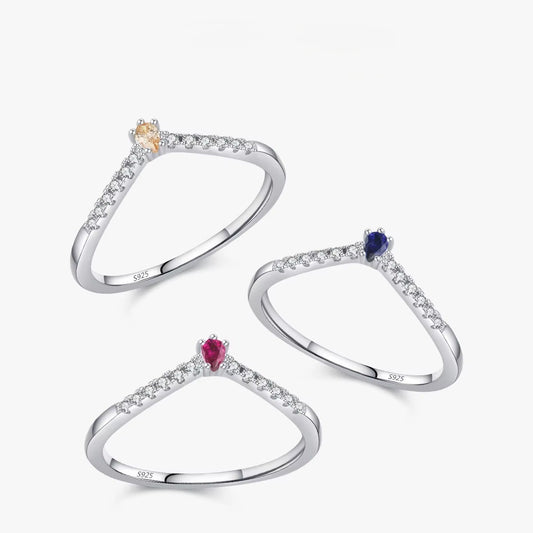 Three silver rings with gemstones on a white background