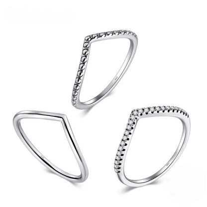 Three silver triangle rings with beaded edges on a white background