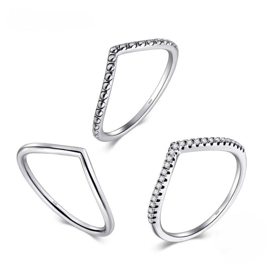 Three silver triangle rings with beaded edges on a white background