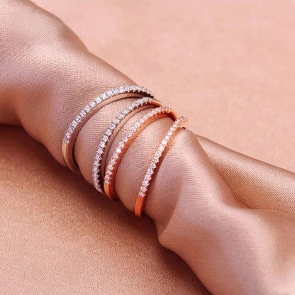 Multiple zircon rings on a beige fabric background